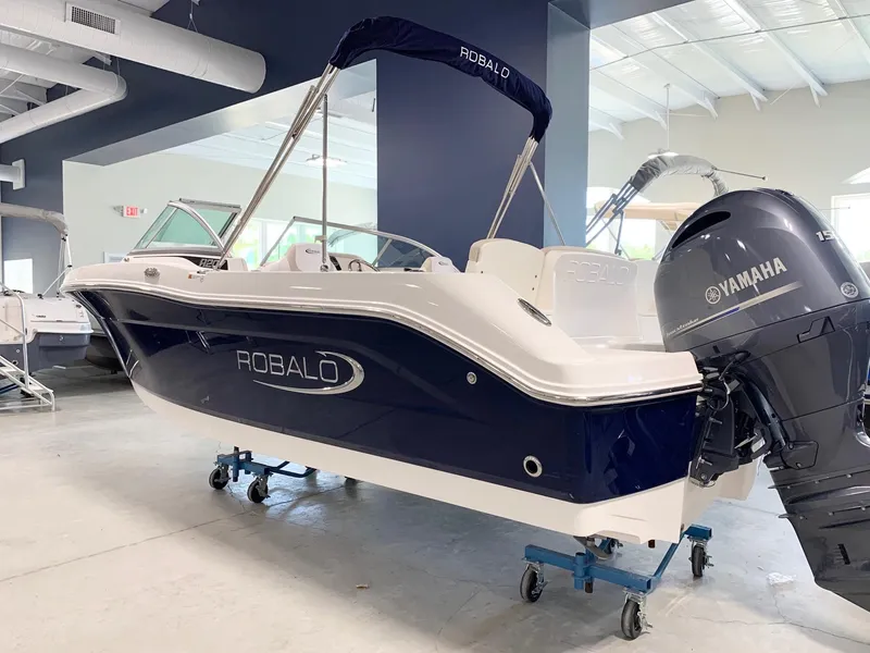 Slide: The Image of 2024 Robalo R207 Dual Console boat with Yamaha outboard motor in showroom. - 1
