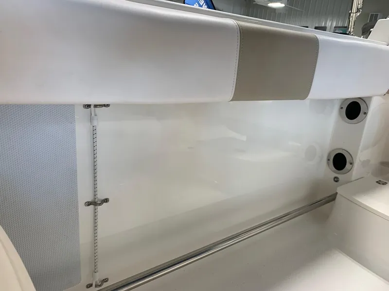 Slide: The Image of 2024 Robalo R207 Dual Console interior detail, white seating and storage area. - 19