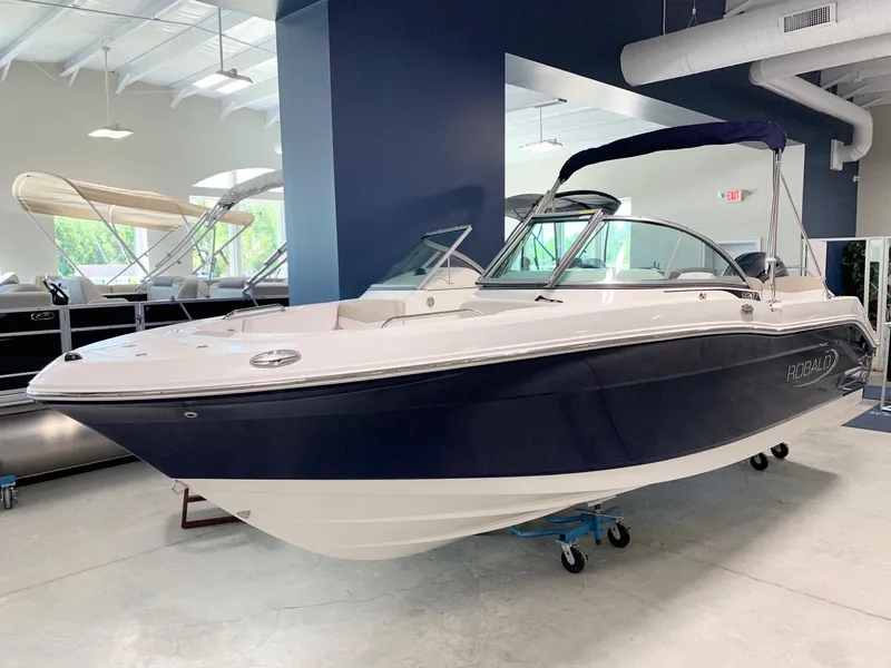 Slide: The Image of 2024 Robalo R207 Dual Console boat in showroom. - 2