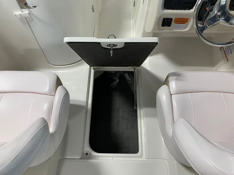Slide: The Image of 2024 Robalo R207 Dual Console boat interior with open storage compartment. - 20