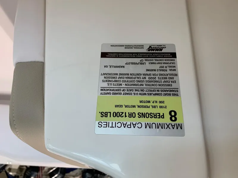 Slide: The Image of 2024 Robalo R207 Dual Console maximum capacity label, 8 persons or 1200 lbs. - 21