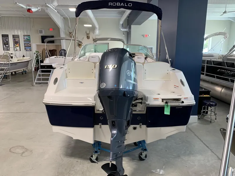 Slide: The Image of 2024 Robalo R207 Dual Console boat with Yamaha 140 outboard motor in showroom. - 3