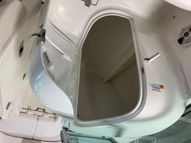 Slide: The Image of 2024 Robalo R207 Dual Console storage compartment with open hatch. - 13