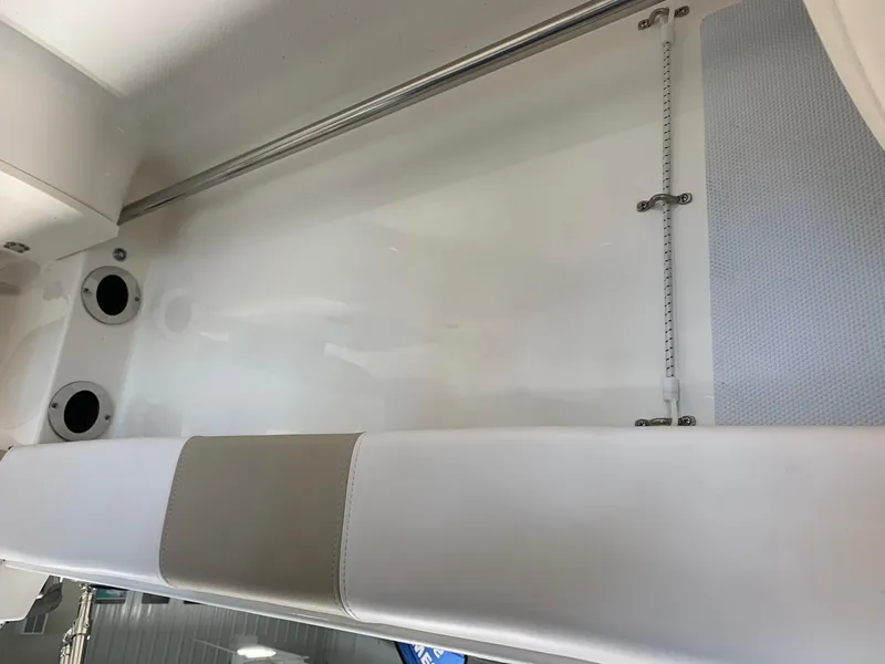 Slide: The Image of 2024 Robalo R207 Dual Console interior seating and storage area. - 18