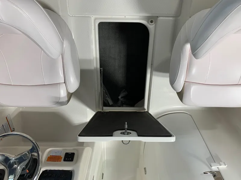 Slide: The Image of 2024 Robalo R207 Dual Console interior with white seats and center console. - 19