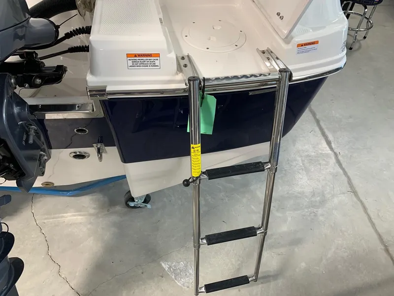 Slide: The Image of 2024 Robalo R207 Dual Console boat with a stainless steel boarding ladder. - 21