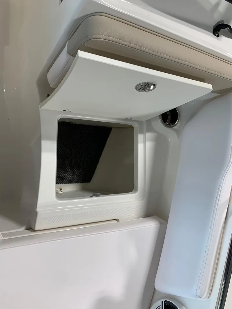 Slide: The Image of 2024 Robalo R207 Dual Console storage compartment. - 7