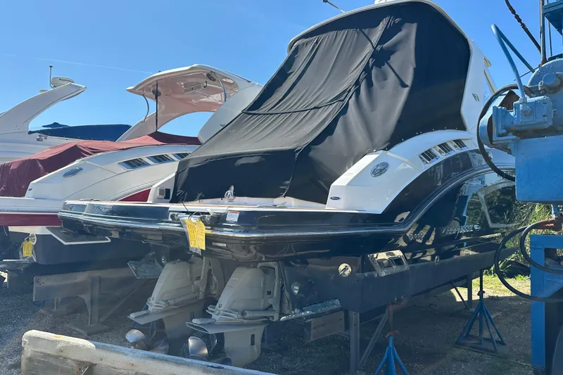 Slide: The Image of 2019 Chaparral 347 SSX boat with covered stern, displayed outdoors. - 1