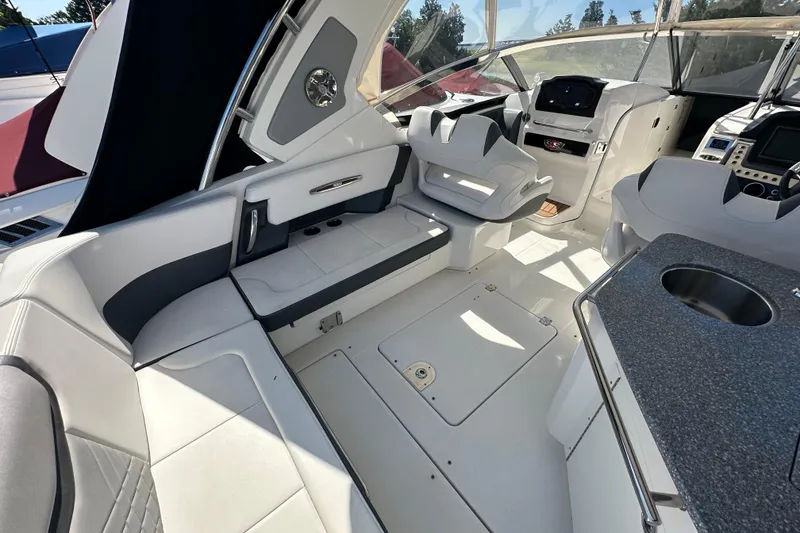 Slide: The Image of 2019 Chaparral 347 SSX boat interior with seating, helm, and kitchenette area. - 11