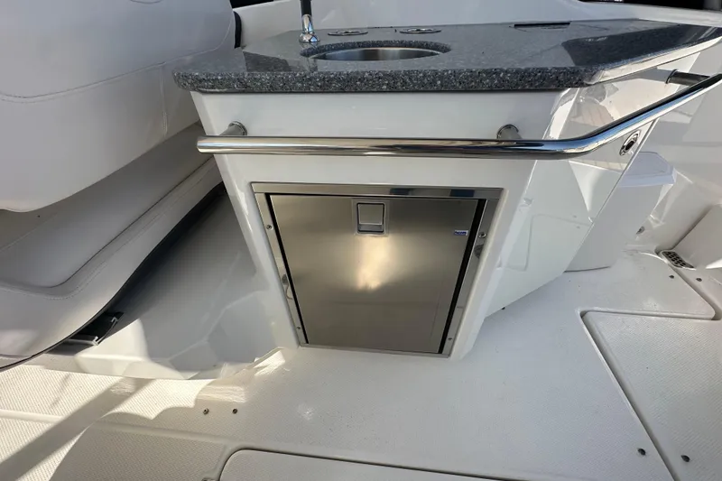 Slide: The Image of 2019 Chaparral 347 SSX boat interior with stainless steel cabinet and countertop. - 12