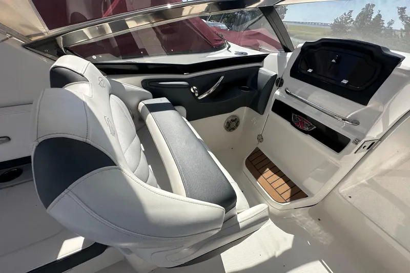 Slide: The Image of 2019 Chaparral 347 SSX boat interior with sleek seating and modern dashboard design. - 14