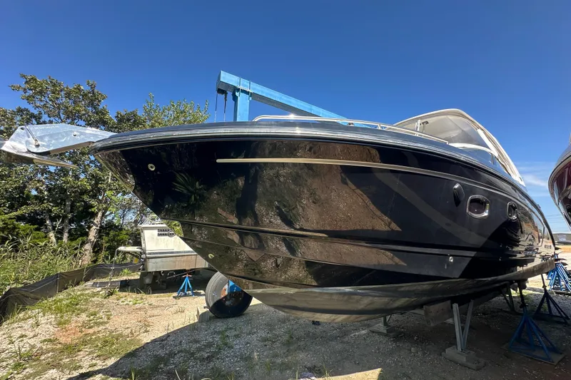 Slide: The Image of 2019 Chaparral 347 SSX boat on stands, under clear blue sky. - 2