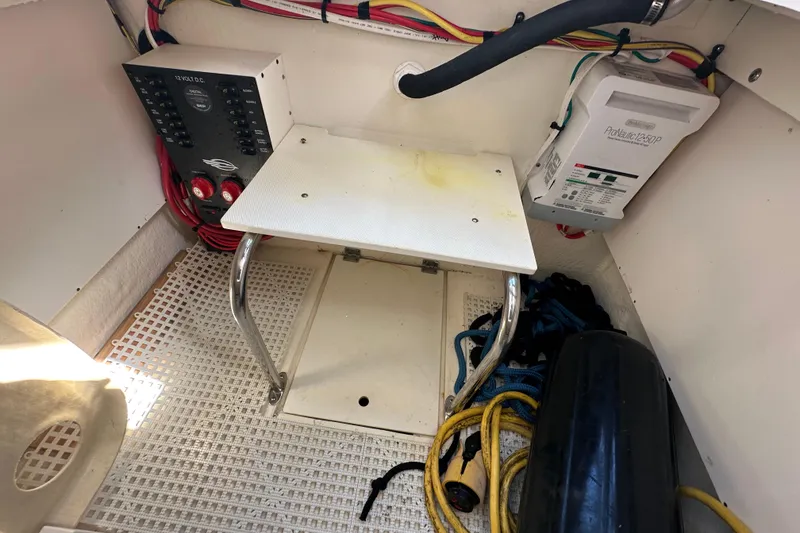 Slide: The Image of 2019 Chaparral 347 SSX boat interior with electrical panel and storage area. - 20