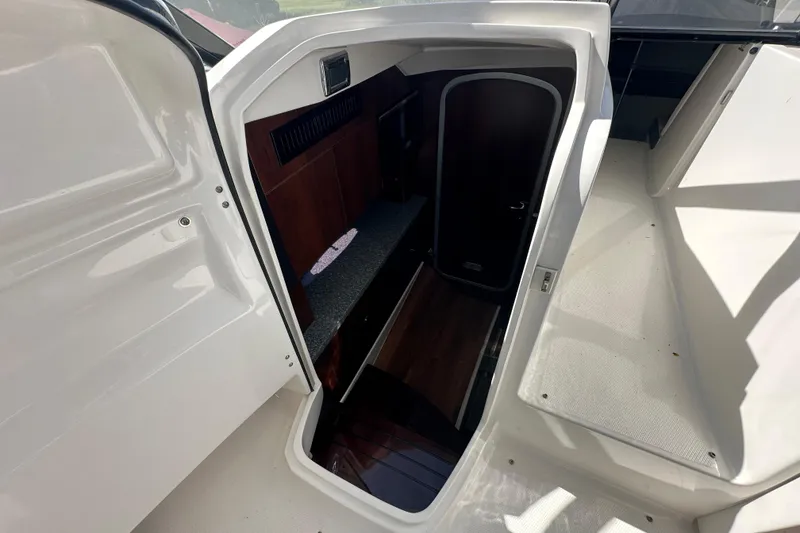 Slide: The Image of Interior cabin entrance of 2019 Chaparral 347 SSX boat, featuring sleek design and wood accents. - 21