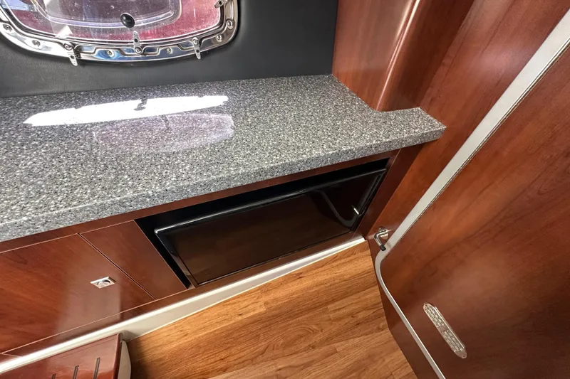 Slide: The Image of 2019 Chaparral 347 SSX interior with granite countertop and wooden cabinetry. - 24