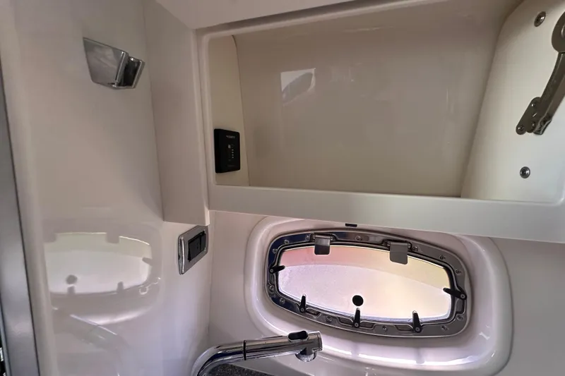 Slide: The Image of Interior of 2019 Chaparral 347 SSX boat, featuring a window and storage compartment. - 27
