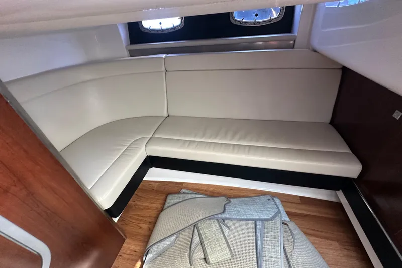 Slide: The Image of Interior cabin of 2019 Chaparral 347 SSX with white leather seating and wooden flooring. - 28