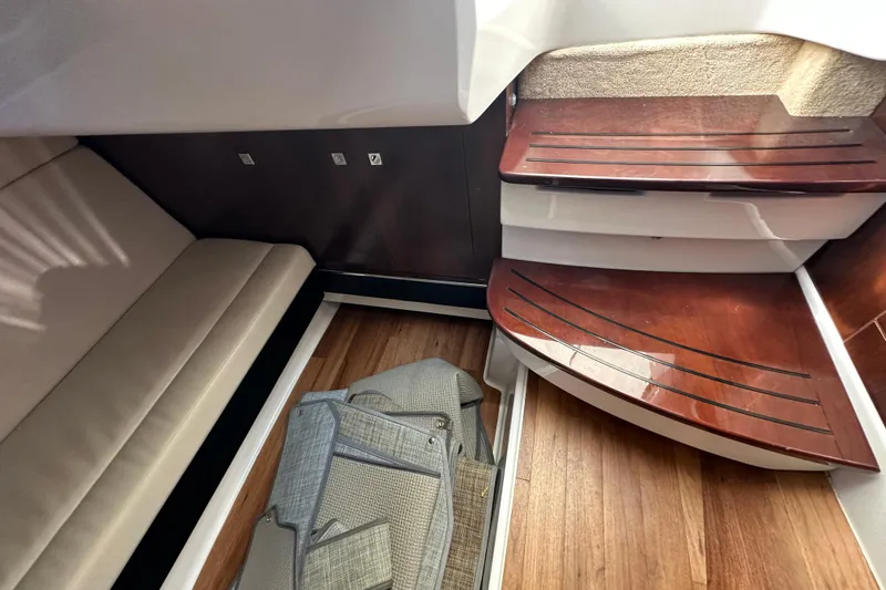 Slide: The Image of 2019 Chaparral 347 SSX interior with wooden steps and beige seating. - 29