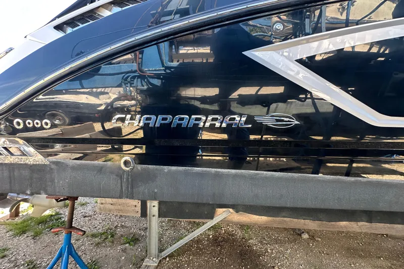 Slide: The Image of 2019 Chaparral 347 SSX boat side view with logo and sleek design. - 3