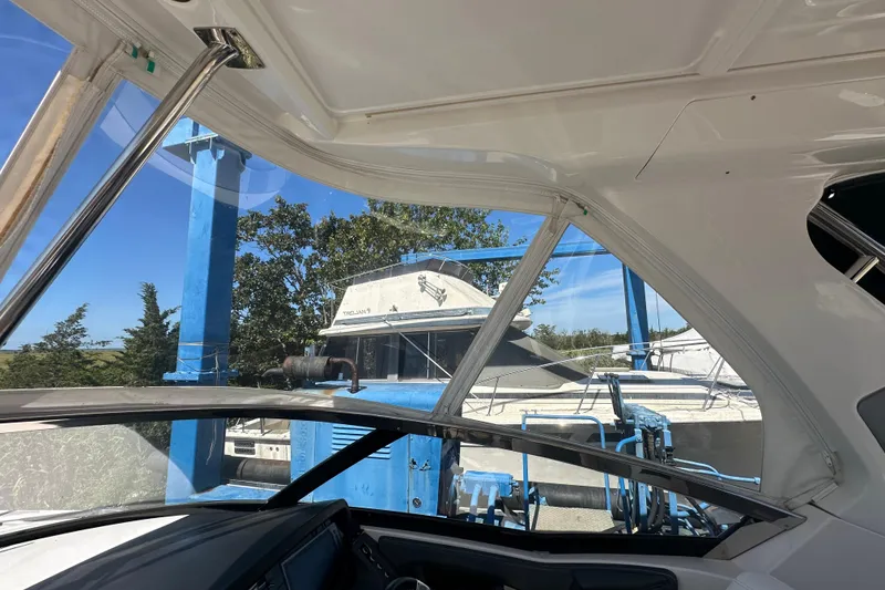 Slide: The Image of Interior view of a 2019 Chaparral 347 SSX boat with marina background. - 32