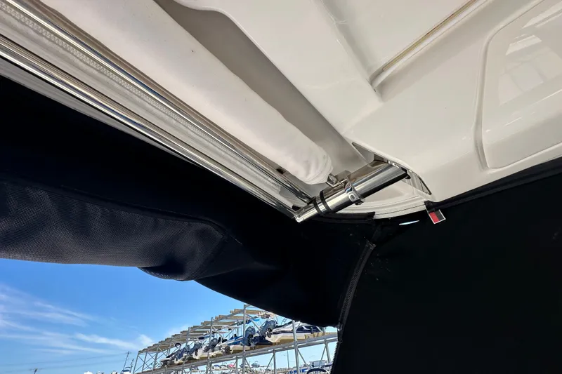 Slide: The Image of 2019 Chaparral 347 SSX boat canopy mechanism with blue sky background. - 34