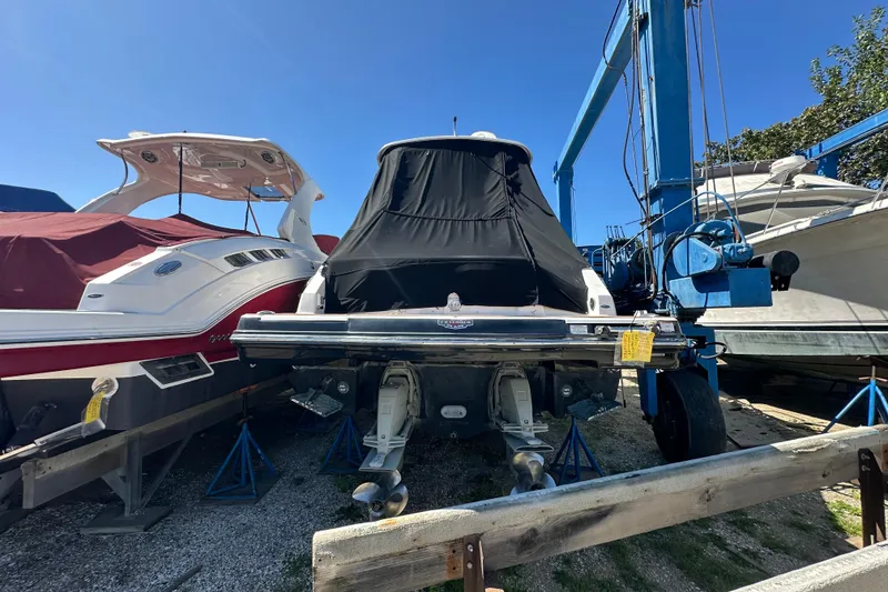 Slide: The Image of 2019 Chaparral 347 SSX boat in storage, covered, with other boats nearby. - 4