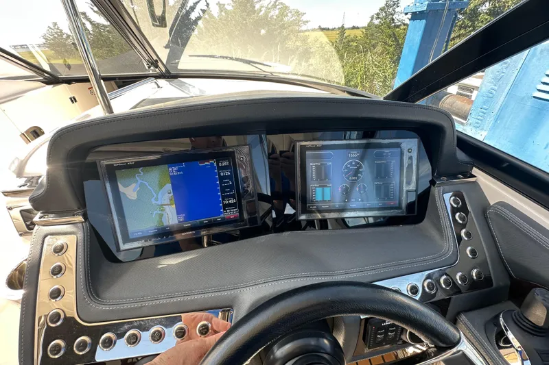 Slide: The Image of 2019 Chaparral 347 SSX dashboard with dual navigation screens and control buttons. - 41