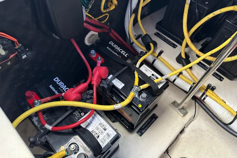 Slide: The Image of 2019 Chaparral 347 SSX boat battery compartment with Duracell batteries and wiring. - 52