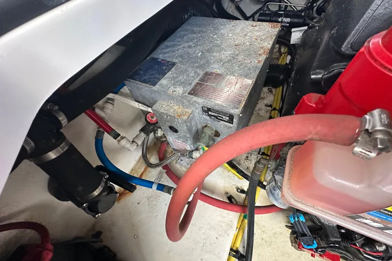Slide: The Image of Engine compartment of a 2019 Chaparral 347 SSX boat, showing various hoses and components. - 55