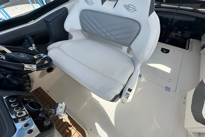 Slide: The Image of 2019 Chaparral 347 SSX boat interior with white captain's seat and steering wheel. - 58
