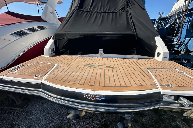 Slide: The Image of 2019 Chaparral 347 SSX boat with teak swim platform and black cover. - 6