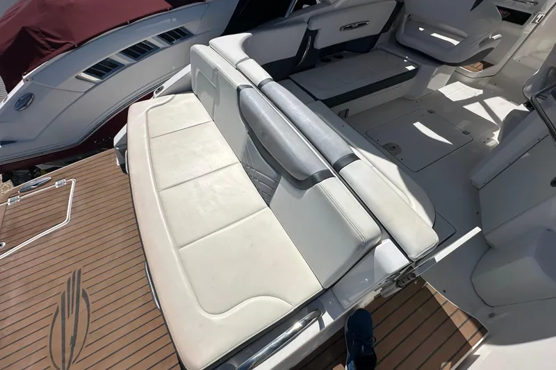Slide: The Image of 2019 Chaparral 347 SSX boat interior with white seating and teak flooring. - 7