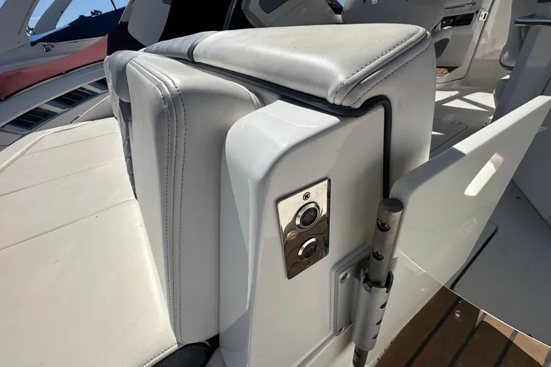 Slide: The Image of 2019 Chaparral 347 SSX boat interior with white seating and control panel. - 9