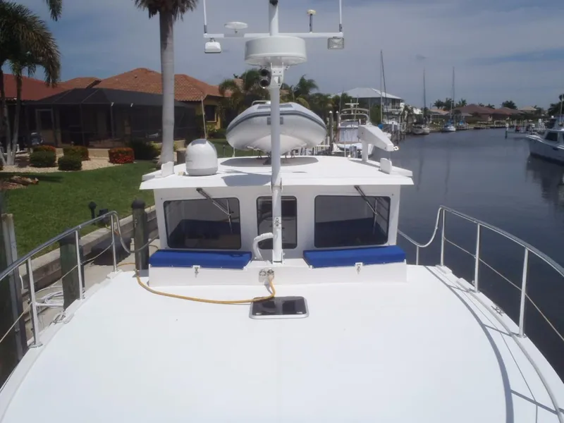 Slide: The Image of Great Harbour N40 yacht docked in a canal, featuring a spacious deck and modern design, 2025 model. - 10