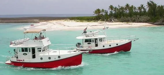 Slide: The Image of Two Great Harbour N40 boats cruising near a tropical island, 2025 model. - 3