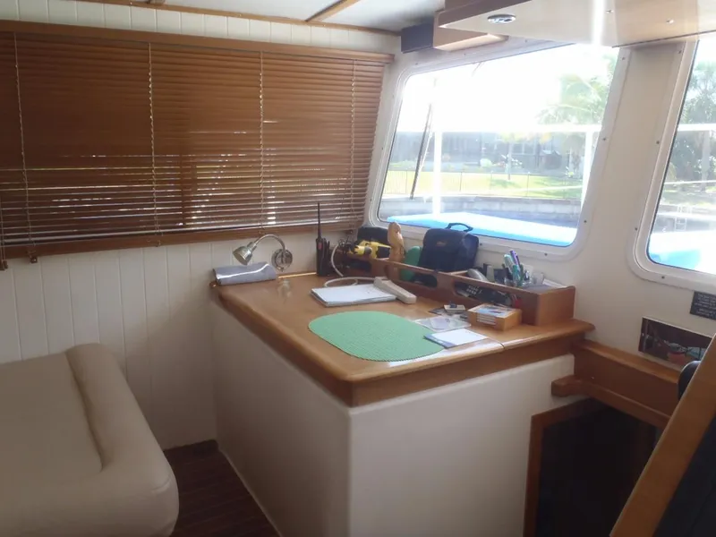 Slide: The Image of Interior of 2025 Great Harbour N40 boat with desk, window, and wooden blinds. - 32