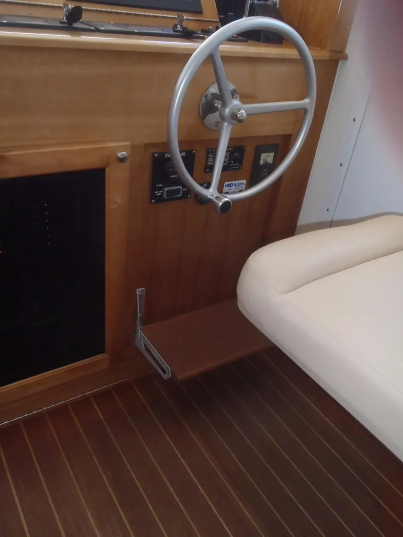 Slide: The Image of Interior helm of 2025 Great Harbour N40 boat with wooden finish and steering wheel. - 34