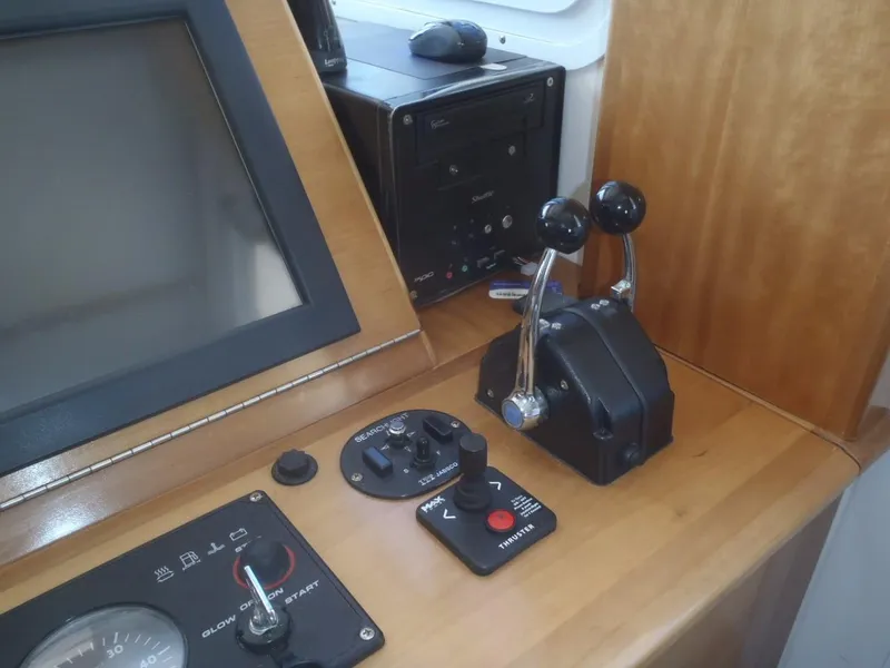 Slide: The Image of Control panel of 2025 Great Harbour N40 boat with throttle levers and navigation screen. - 38