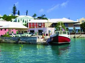 Slide: The Image of Colorful waterfront buildings and a Great Harbour N40 boat docked, 2025. - 4