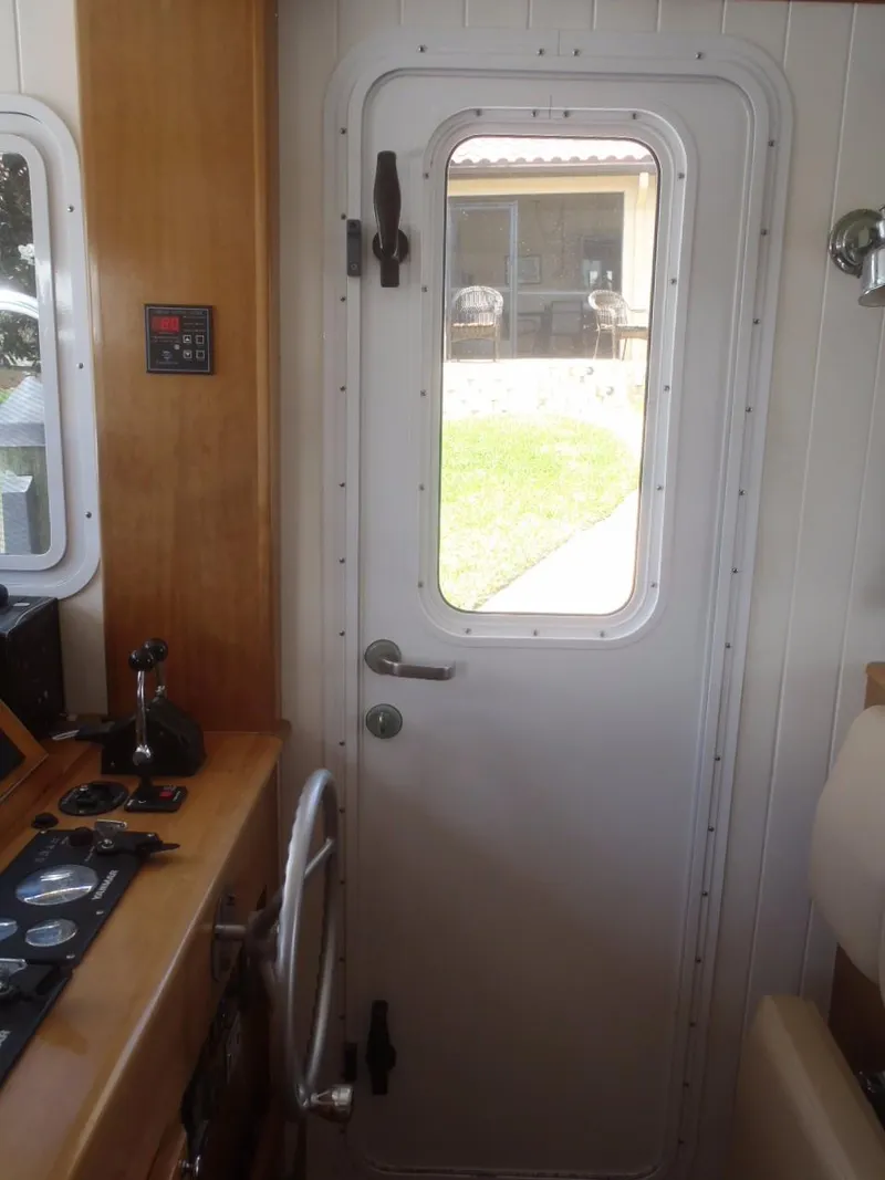 Slide: The Image of Interior view of 2025 Great Harbour N40 boat with control panel and door. - 43