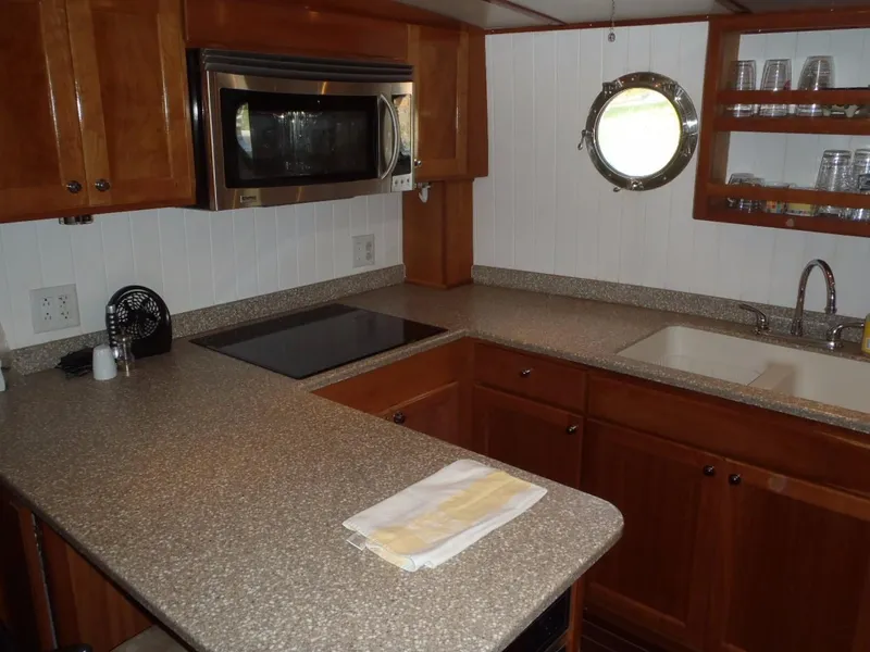 Slide: The Image of Modern kitchen in 2025 Great Harbour N40 yacht with microwave, sink, and porthole window. - 45