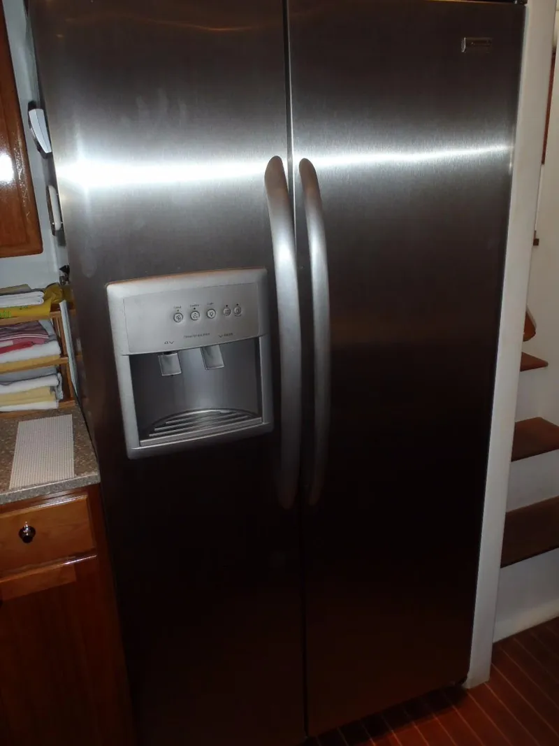 Slide: The Image of Stainless steel refrigerator with ice dispenser in a Great Harbour N40 yacht kitchen, 2025 model. - 48