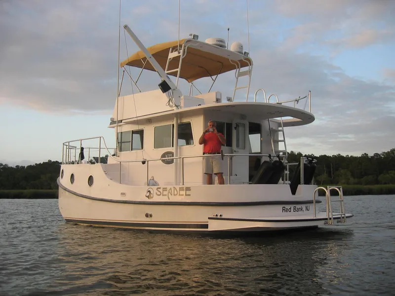 Slide: The Image of Great Harbour N40 boat on water, 2025 model, with person on deck. - 5