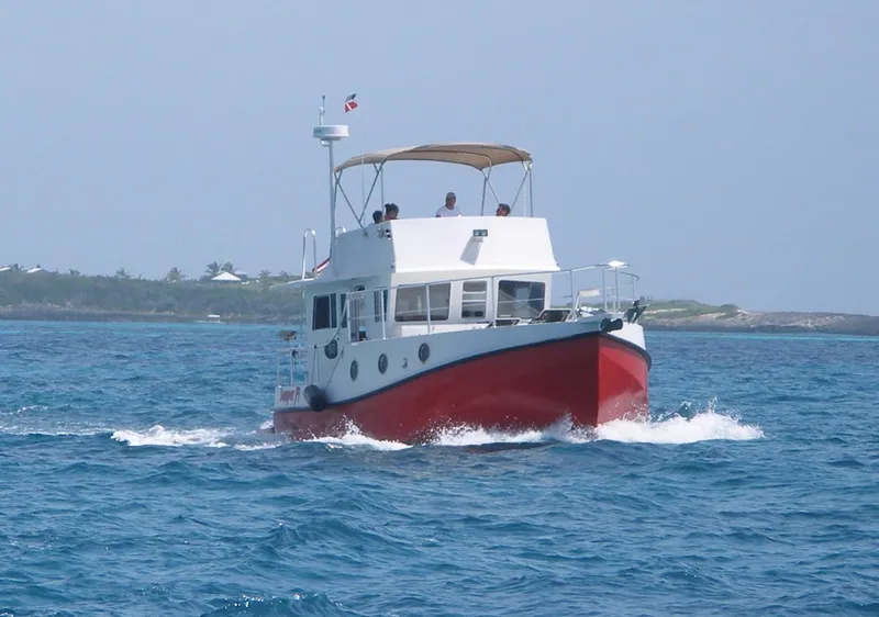 Slide: The Image of 2025 Great Harbour N40 boat cruising on open water with a red hull. - 6