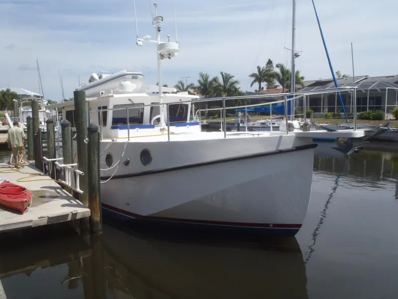 Slide: The Image of Great Harbour N40 yacht docked at marina, 2025 model, with palm trees in background. - 7