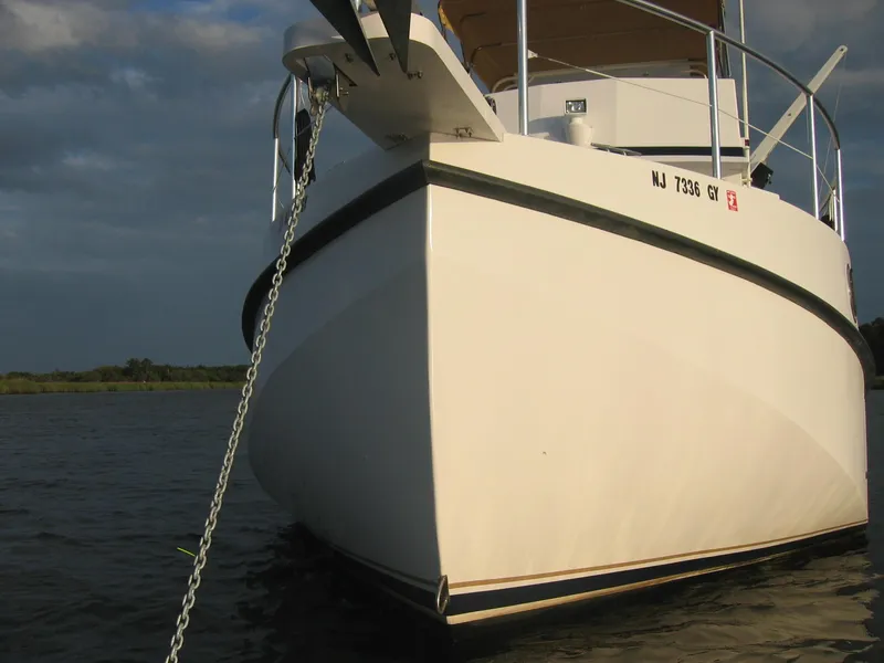 Slide: The Image of Great Harbour N40 boat anchored on water, showcasing its sleek design, 2025 model. - 8