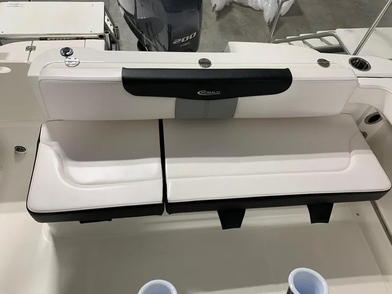 Slide: The Image of 2024 Robalo R222 Explorer boat with white cushioned seating. - 6