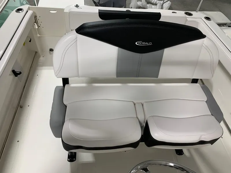 Slide: The Image of 2024 Robalo R222 Explorer boat seating with white and black upholstery. - 7