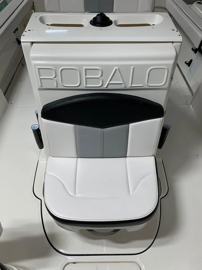 Slide: The Image of 2024 Robalo R222 Explorer boat seat with white and black upholstery. - 10