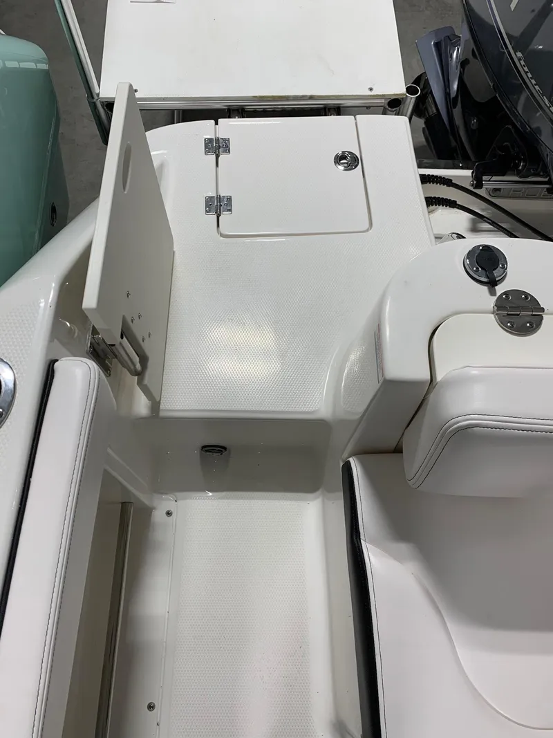 Slide: The Image of 2024 Robalo R222 Explorer boat deck with storage compartments and seating. - 4